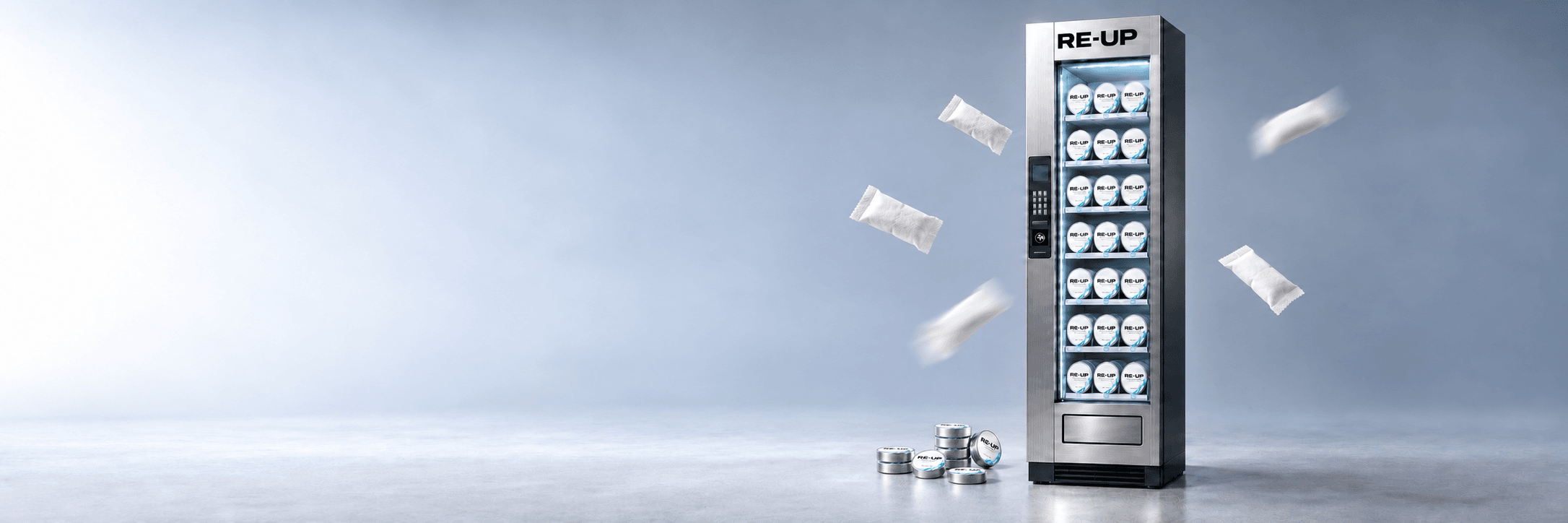 A tall Re-Up vending machine stocked with Focus Pouches tins, white pouches tumbling around it and a stack of tins at its foot, on a studio floor that fades from white to slate.